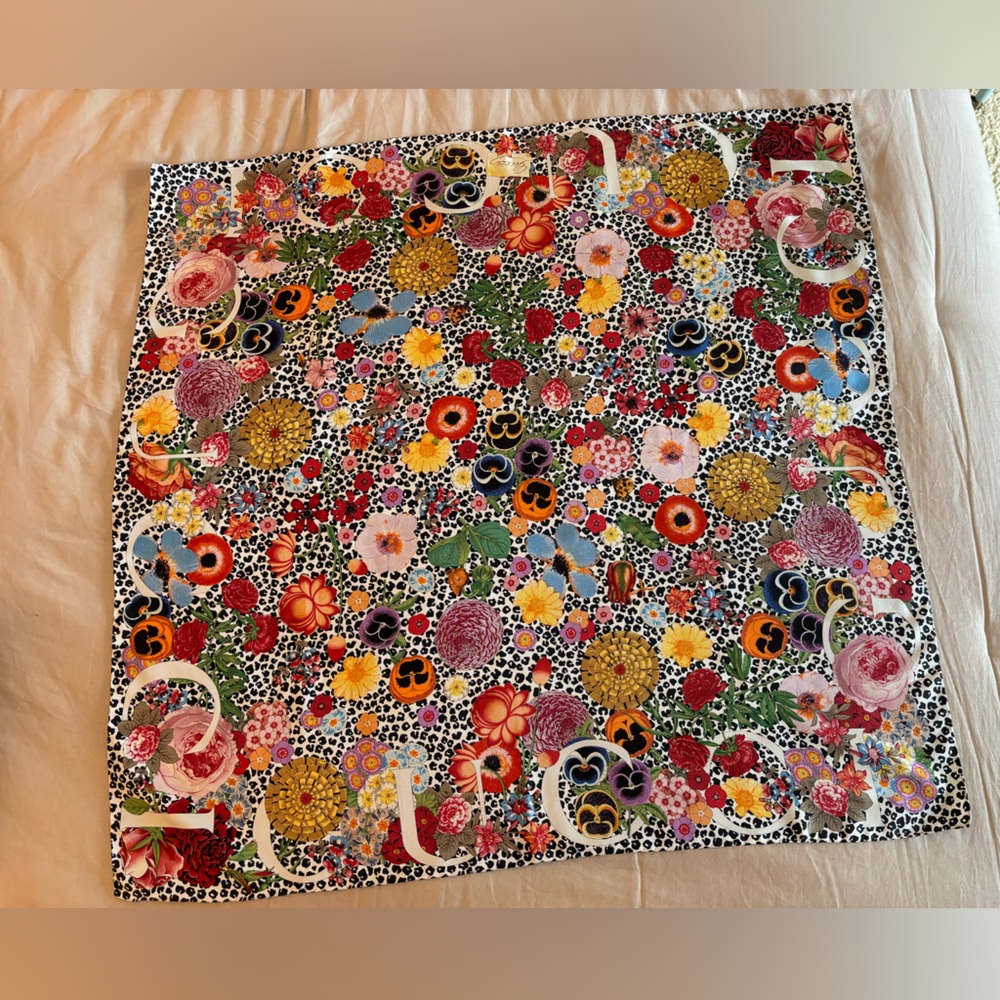 Gucci 100% silk scarf, floral on animal print field.